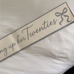 She’s tying up her 20s  with Bow sticker